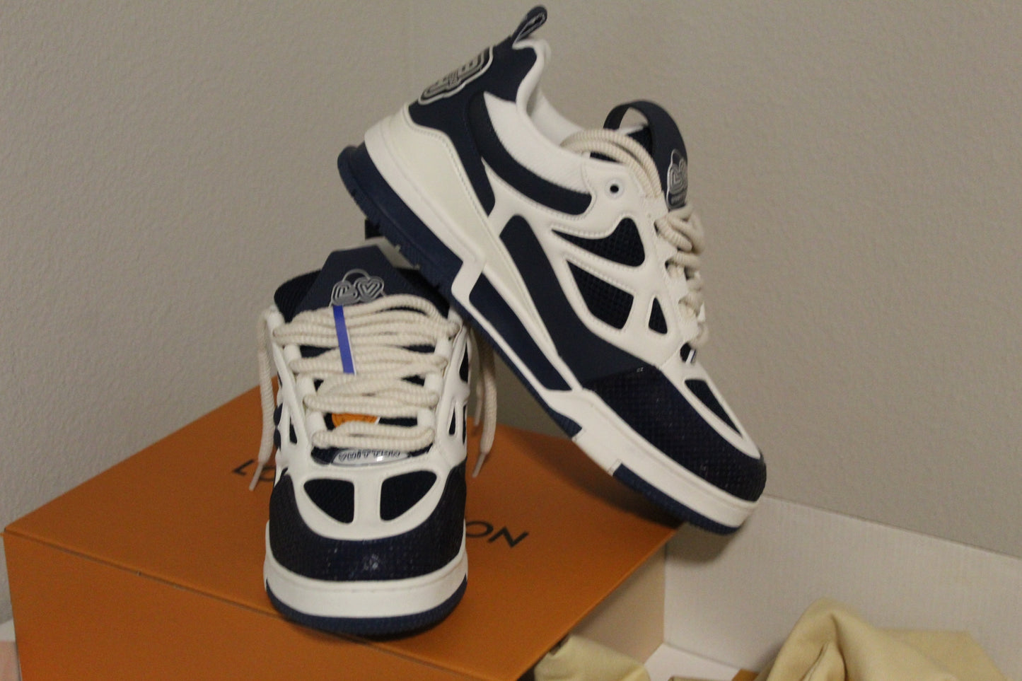 Louis Vuitton LV Skate Sneakers in a navy blue and white colorway.