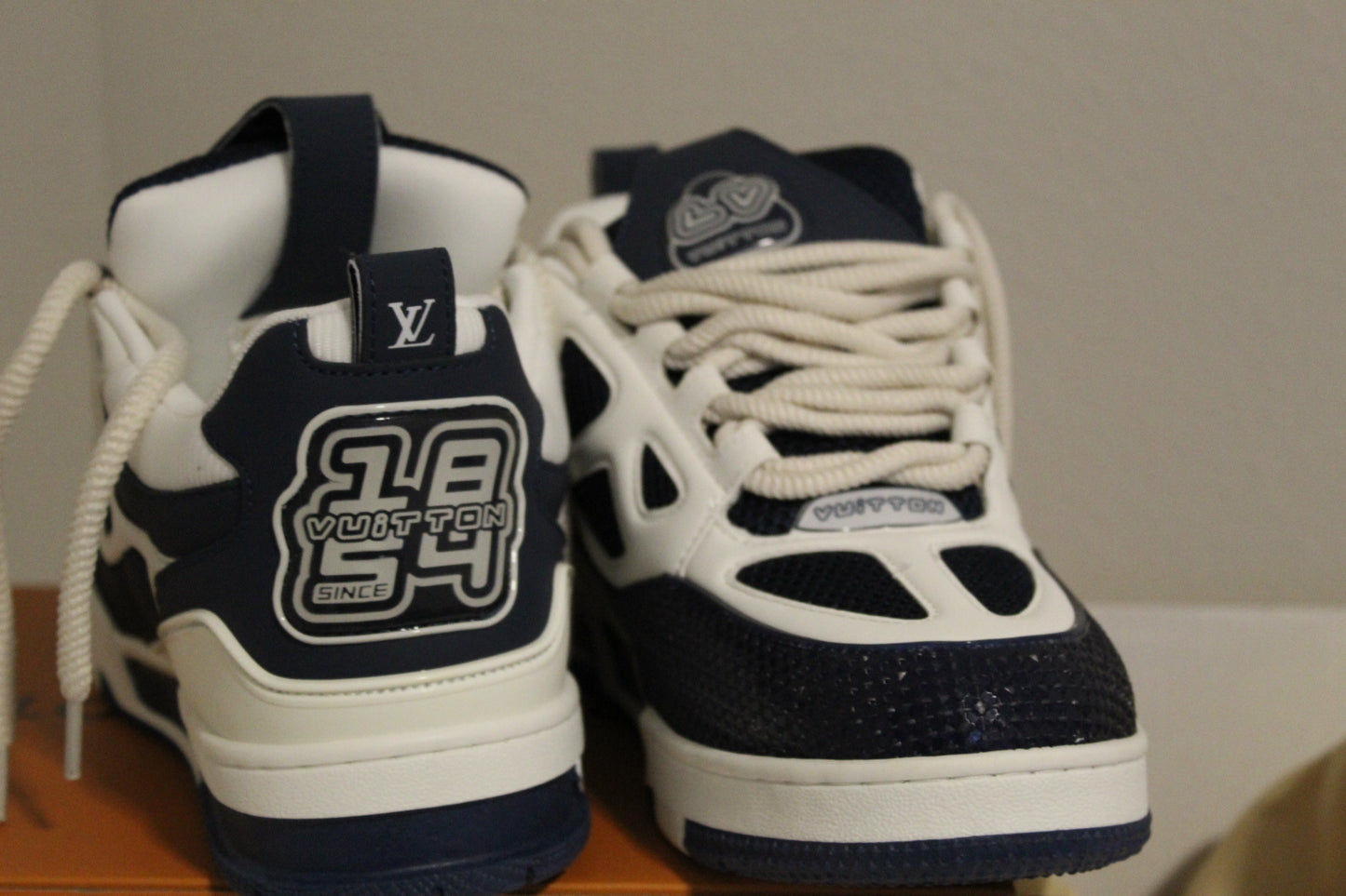 Louis Vuitton LV Skate Sneakers in a navy blue and white colorway.